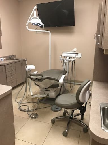 Treatment room at Matlock Family Dental with a dental chair, overhead light and a wall-mounted screen for reviewing X-rays